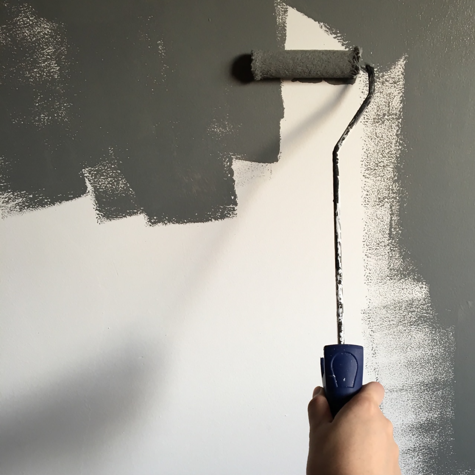 White wall mid-paint with grey, painted by paint roller