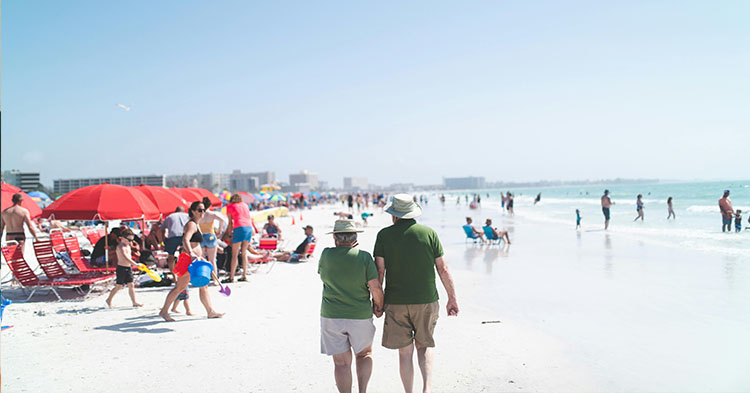 Elderly couple walking on the beach.