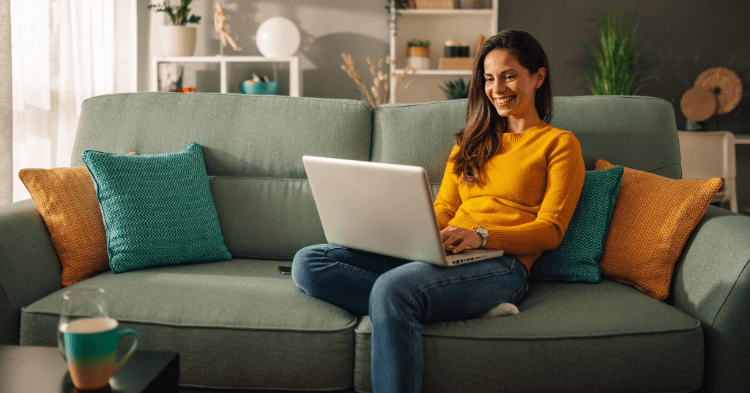Woman sitting on couch with laptop
