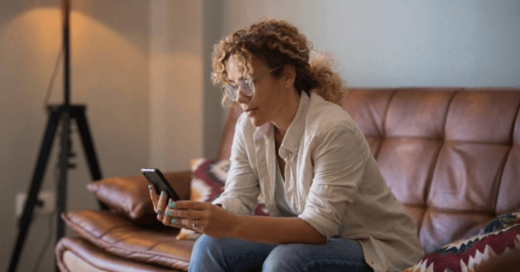 Woman on the couch looking at her phone