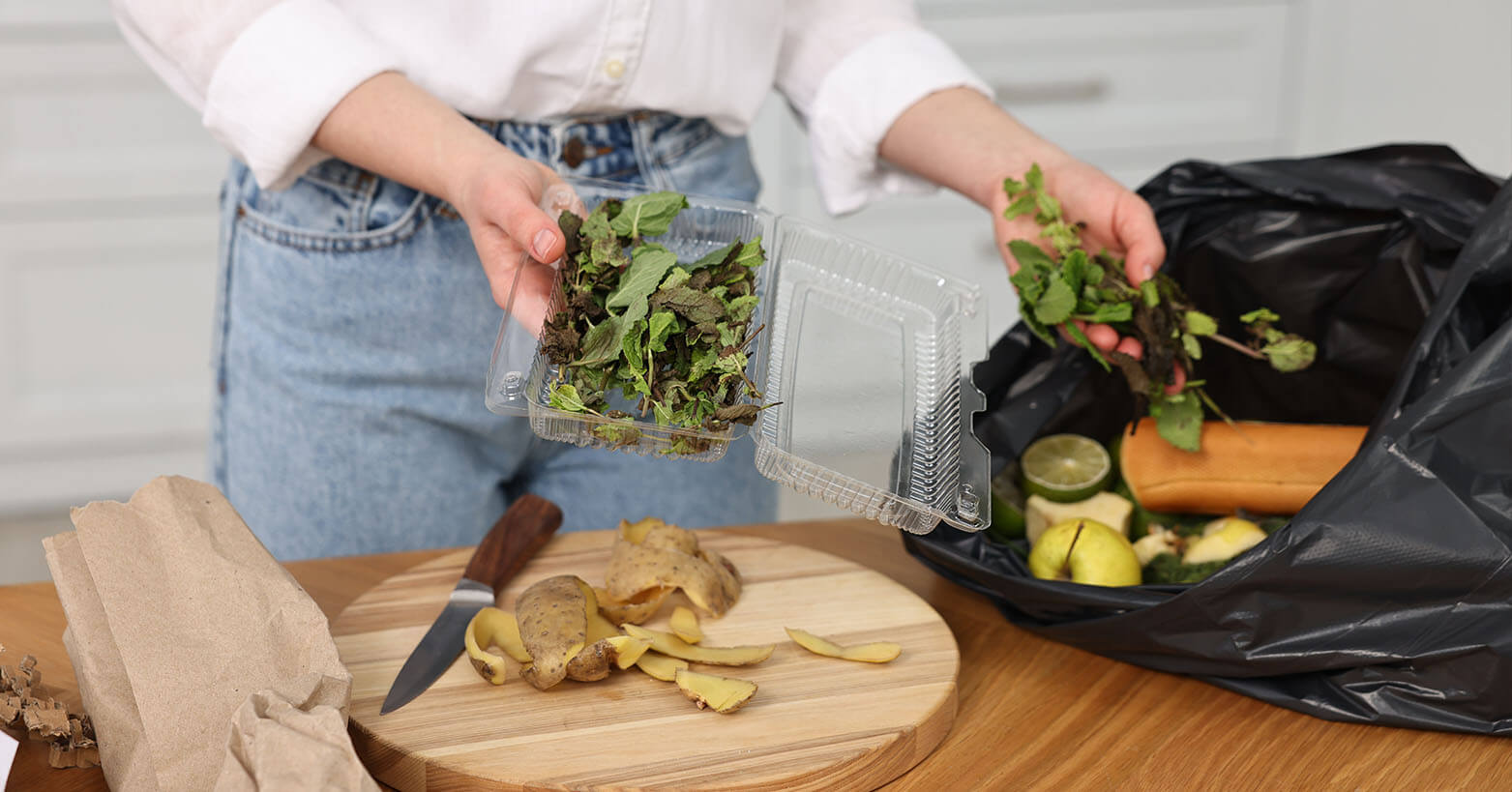 Person saving vegetable scraps to compost