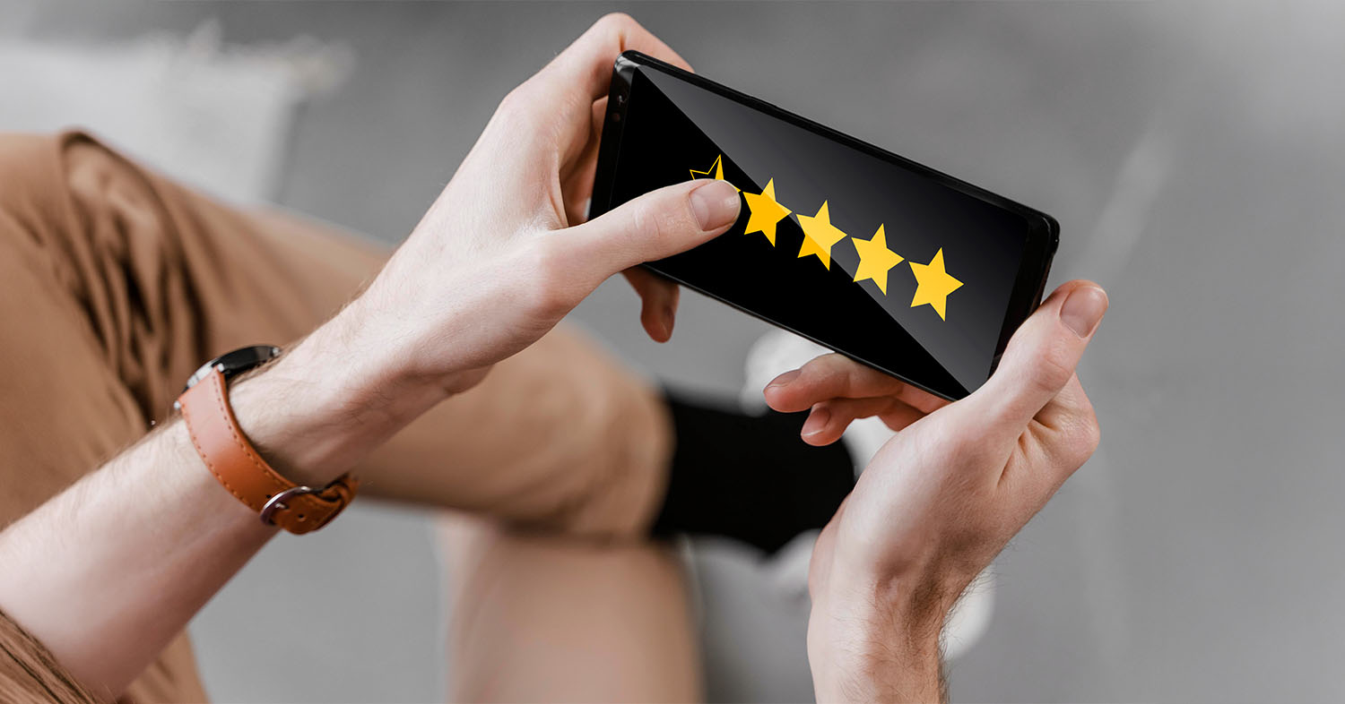 Man looking at customer review rating on mobile device.