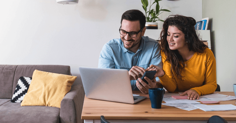 Couple at their laptop at home reviewing their finances
