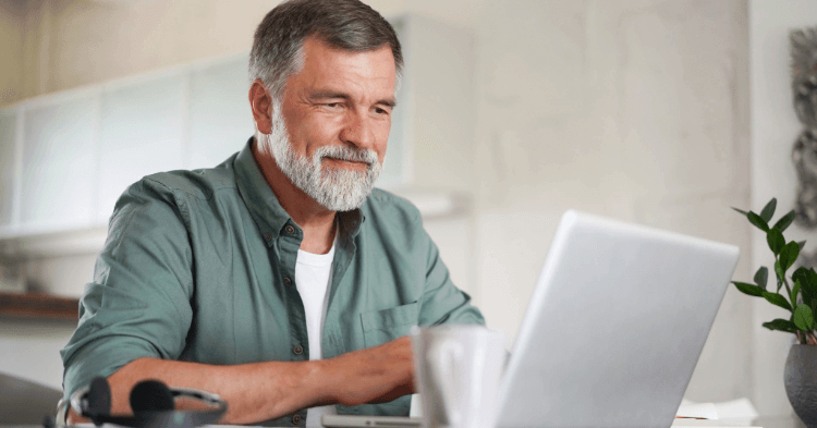 Man sitting at laptop reviewing finances